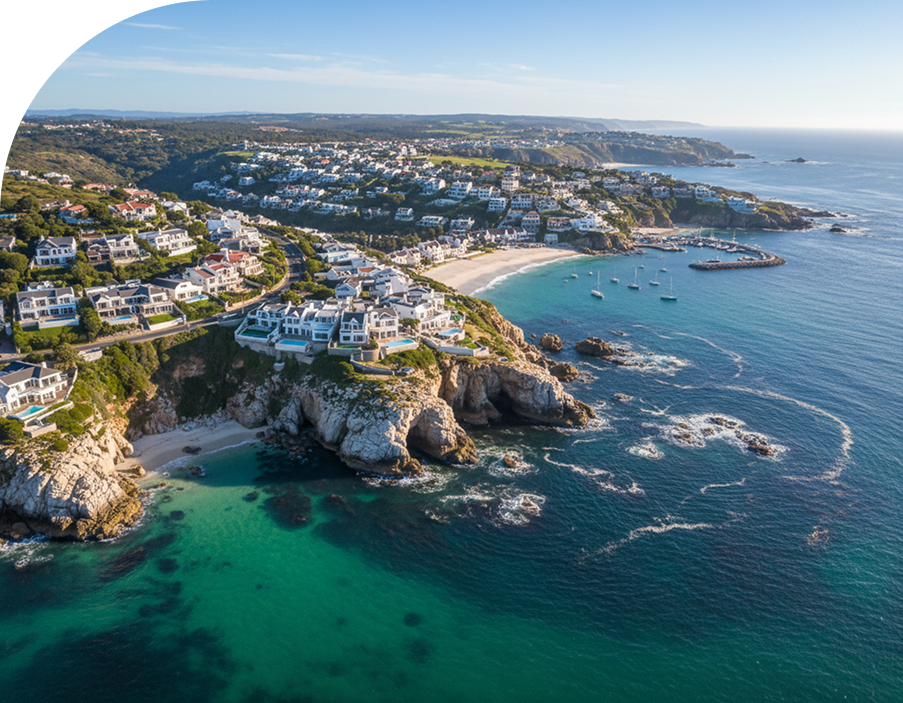 Aerial view of a South African coastal town and turquoise bay.